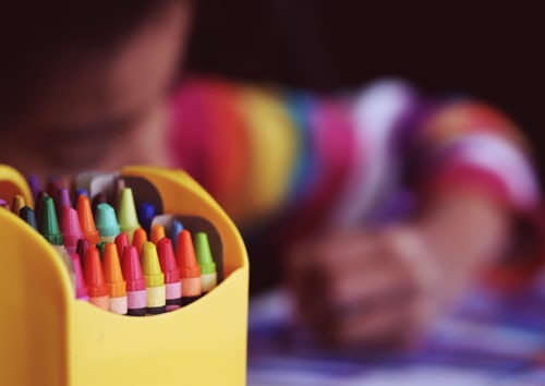 A child coloring with crayons