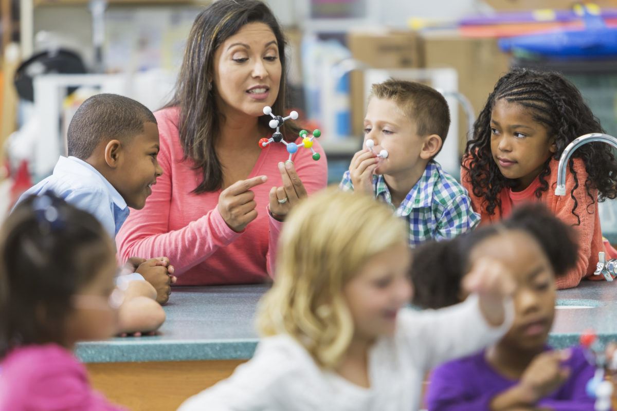 Teacher in front of classroom teaching science