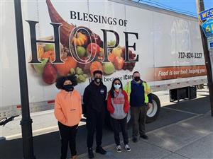 Key Club Students Next to Truck with Food and Hope sign 