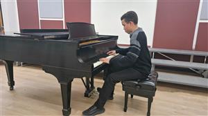 Kimble playing piano