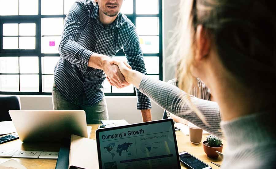 Image of a supervisor shaking hands with an intern